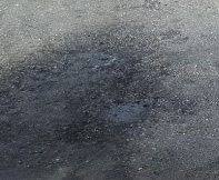 Oil and fuel stains on an asphalt driveway